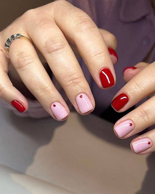 Vibrant pink and red clashing nail art on short squared nails