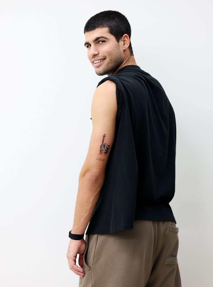 Carlos Alcaraz of Spain poses for a photograph at the Ganga Tattoo Studio with his new tattoo commemorating winning his 6th Grand Slam title at the 2025 US Open in New York.