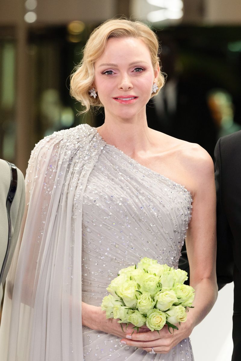 Princess Charlene’s Rose Ball 2026 look: dramatic silver cape gown, diamond jewelry, and her signature soft glam
