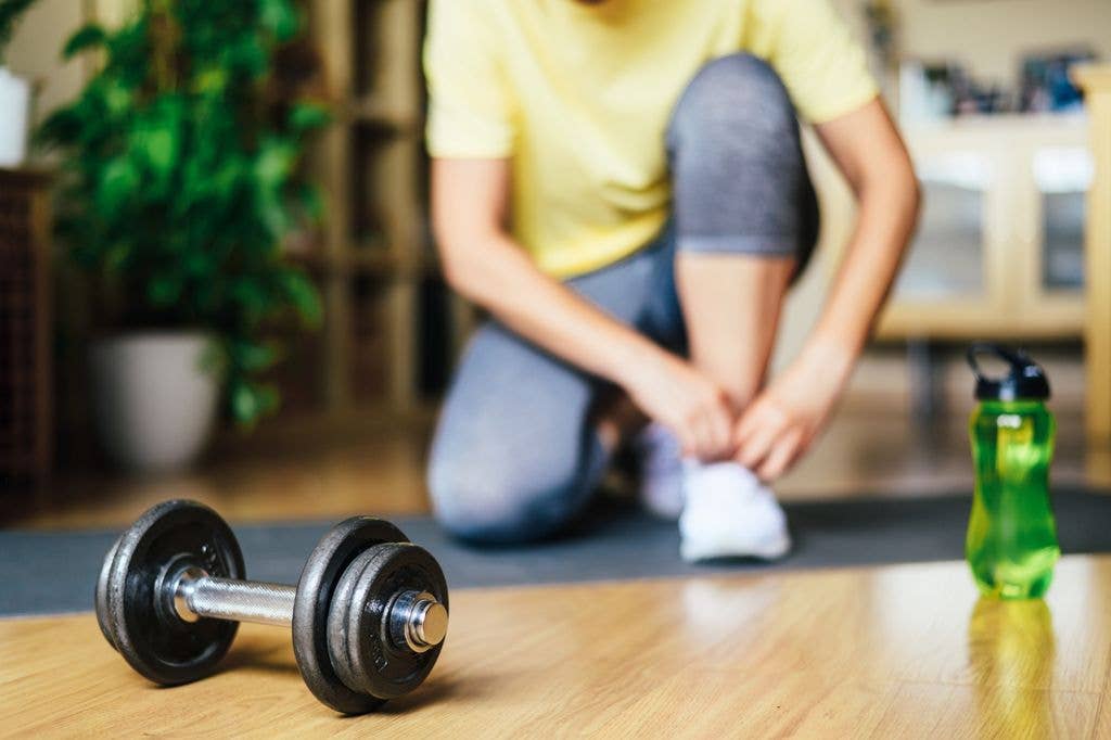 athlete Starting at home Exercise With Dumbbell Weight in morning