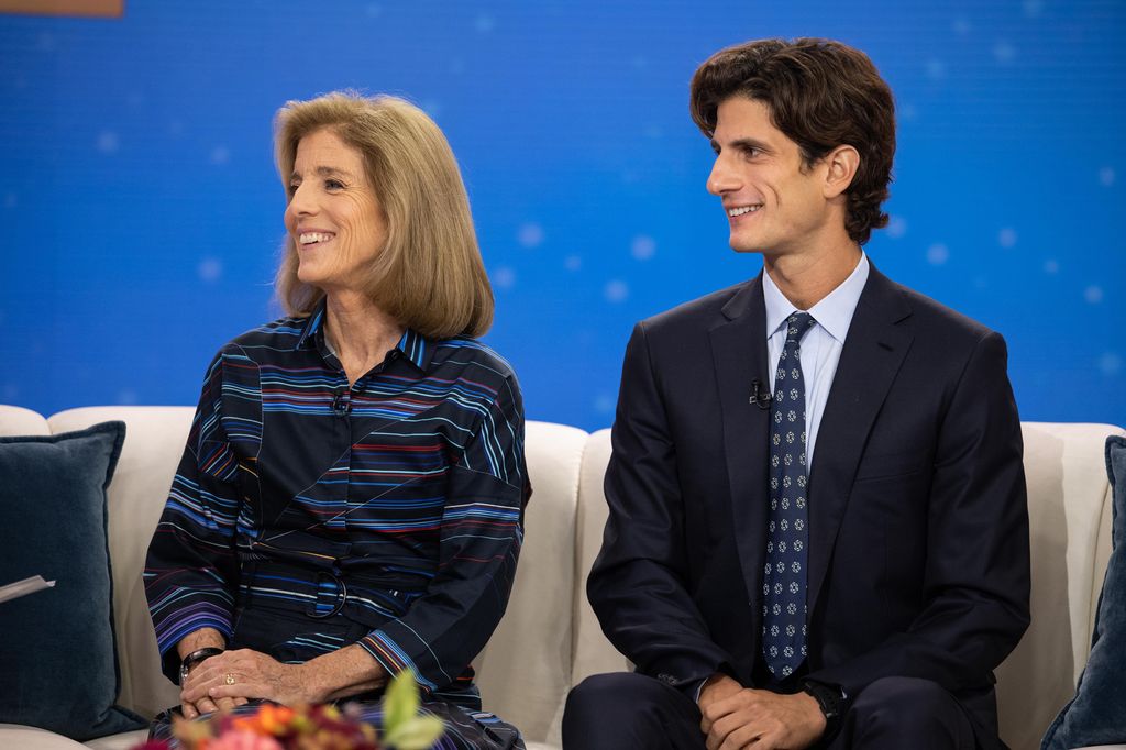 Caroline Kennedy and son Jack Schlossberg sit next to one another on a cream sofa.