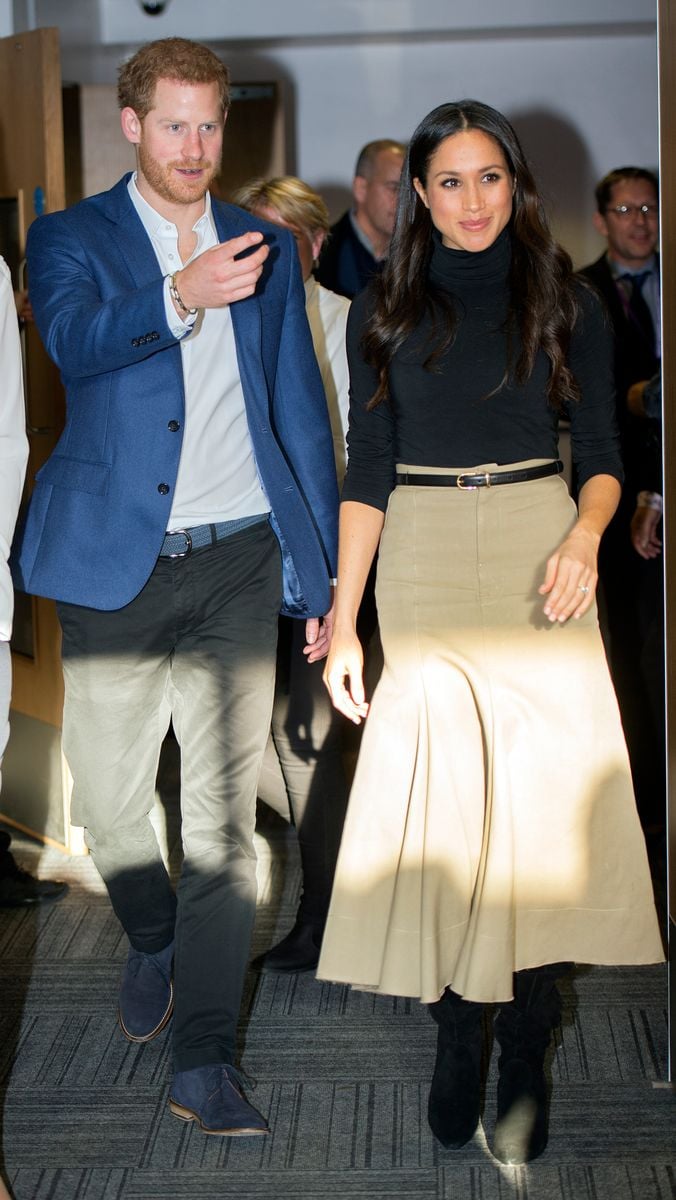 For her first official royal appearance after her engagement to Prince Harry in 2017, Meghan wore a camel Joseph skirt, a fitted black jumper, and knee-high boots, paired with a black purse. 