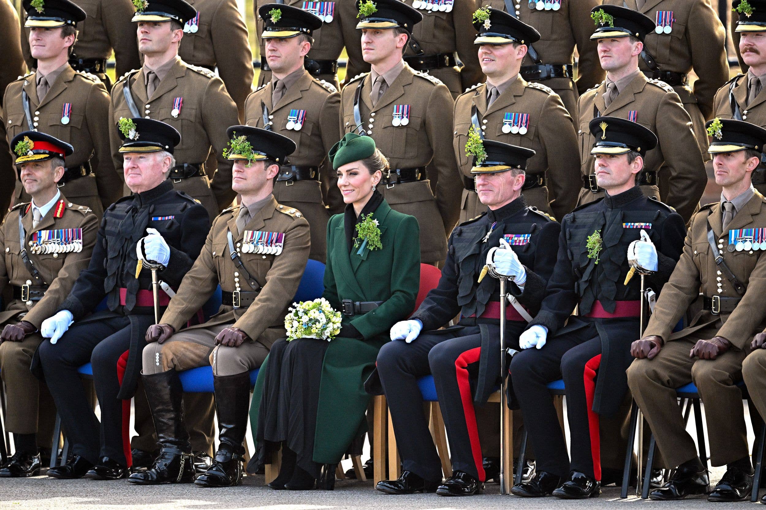 Kate Middleton sitting with a group of military men