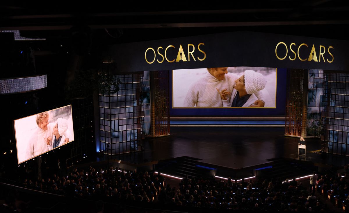 A screen shows late US actor Robert Redford with US singer Barbra Streisand as she speaks during an in memoriam segment onstage during the 98th Annual Academy Awards.