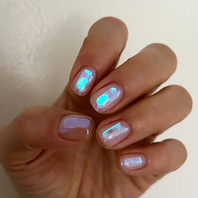 iridescent Aurora nail design on short nails featuring a shimmering, light-reflecting South Korean manicure effect.