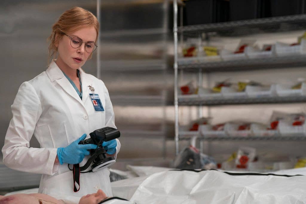 forensic examiner looking at body 