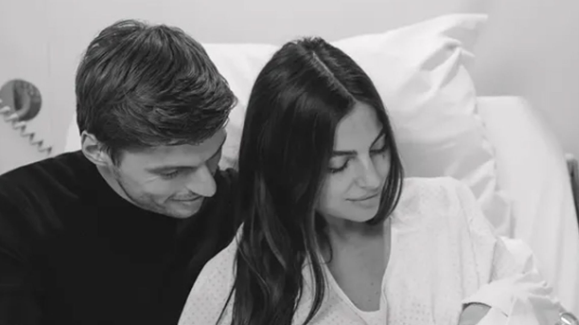 Black-and-white photo of Max Verstappen and Kelly Piquet with their baby