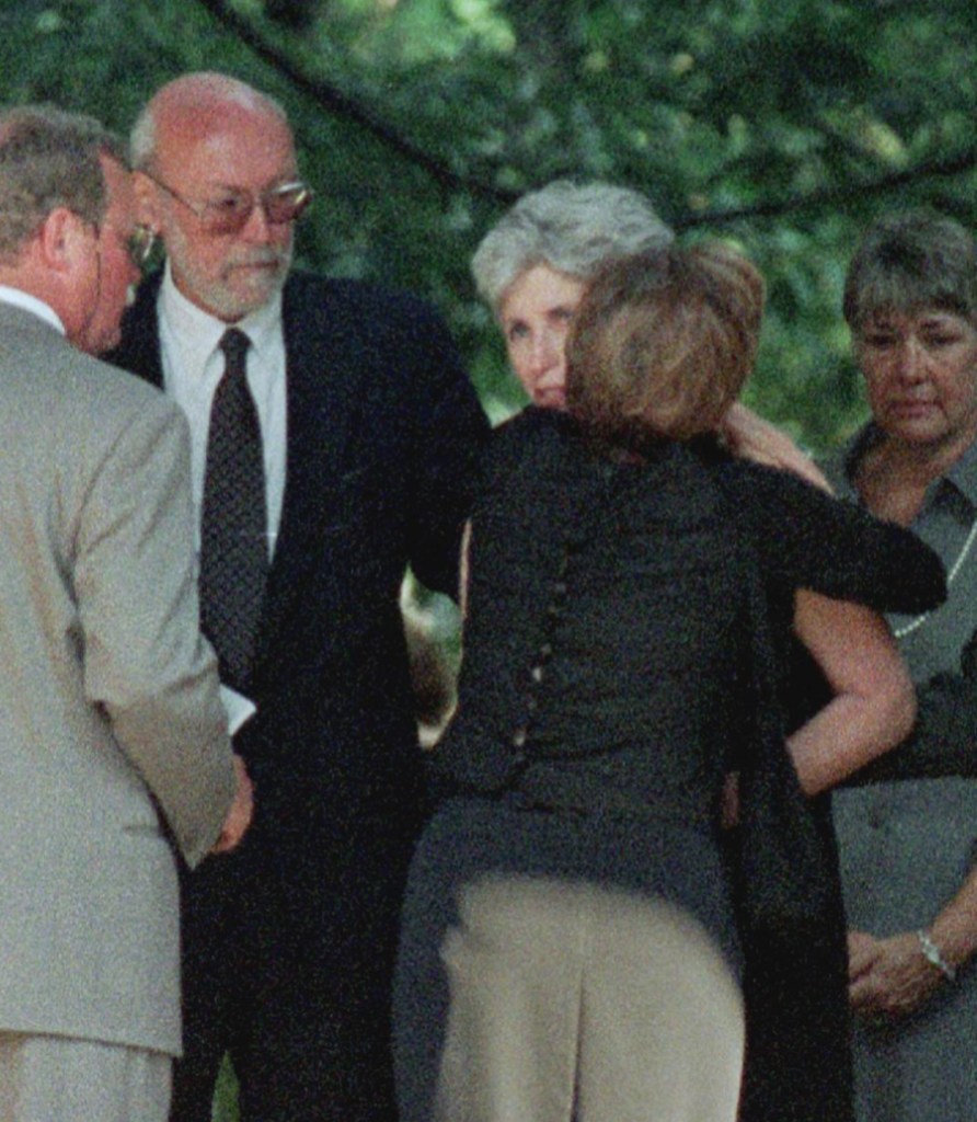 GREENWICH, :  Anne Freeman (2nd R), mother of Lauren Bessette, receives a a hug beside her husband, Richard Freeman (2nd L), shortly before a memorial service for Lauren Bessette 24 July 1999 at Christ Church in Greenwich, Connecticut. Lauren Bessette was killed in a plane crash 16 July 1999 with her sister, Carolyn Bessette Kennedy and brother-in-law John F. Kennedy, Jr.    AFP PHOTO/Stan HONDA (Photo credit should read STAN HONDA/AFP via Getty Images)