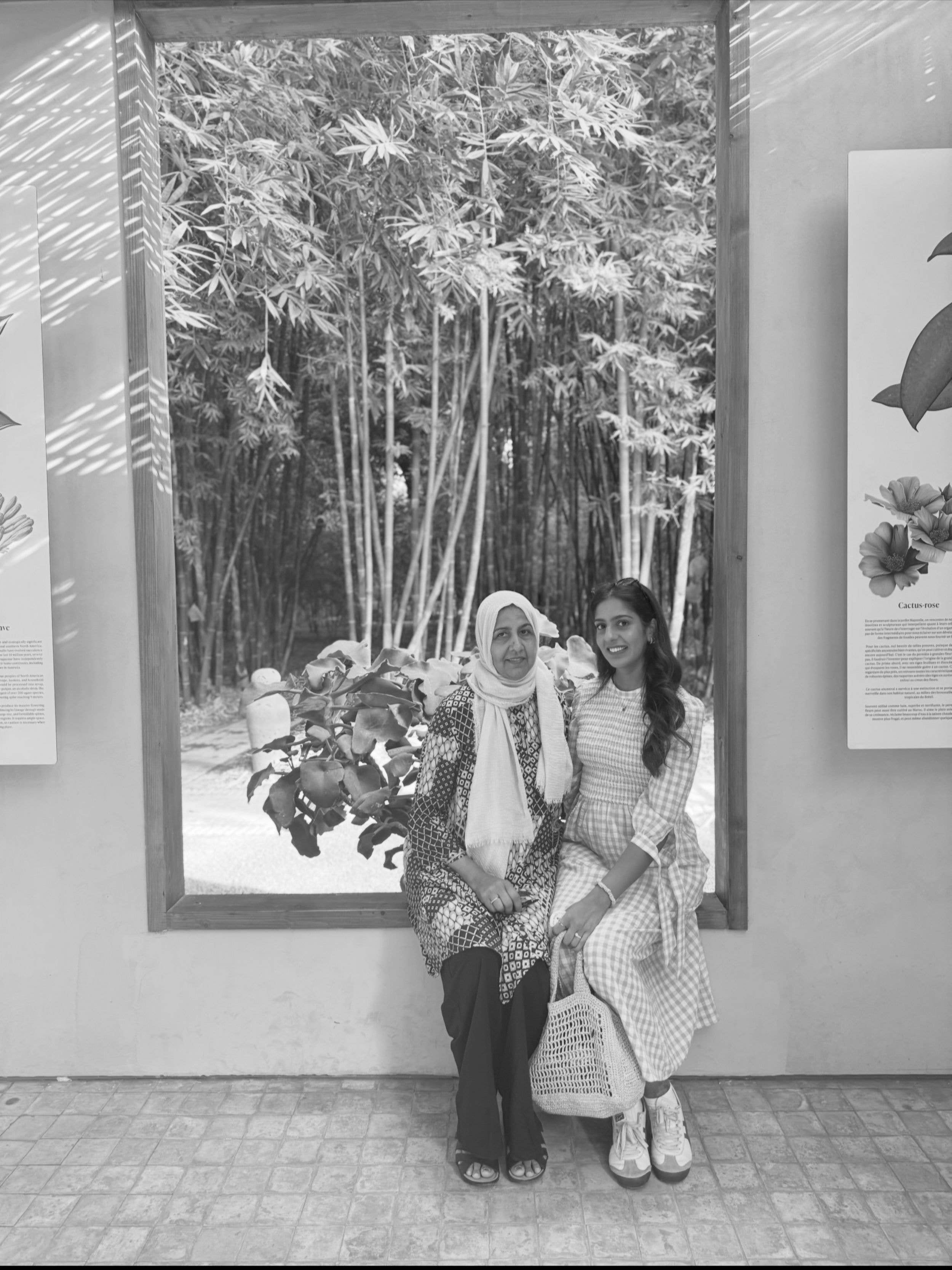 two women sitting in a window 