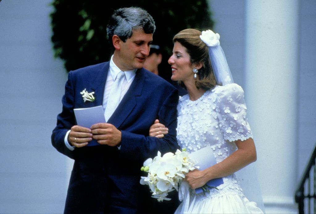 Ed Schlossberg and Caroline Kennedy at their wedding. Caroline tucks one hand into husband Ed's arm.
