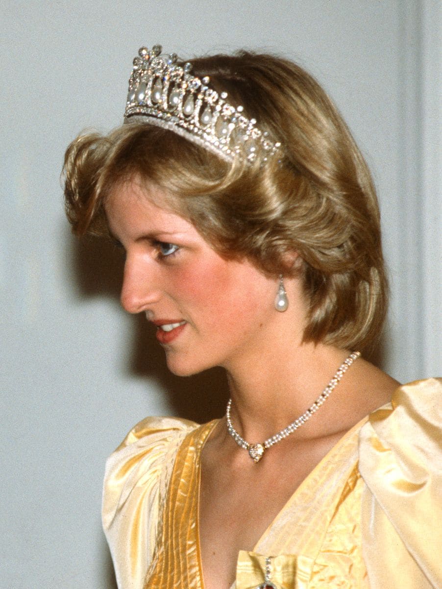 Diana, Princess Of Wales, wearing a yellow satin ballgown designed by Murray Arbeid with the Queen Mary Cambridge Lover's Knot Tiara.