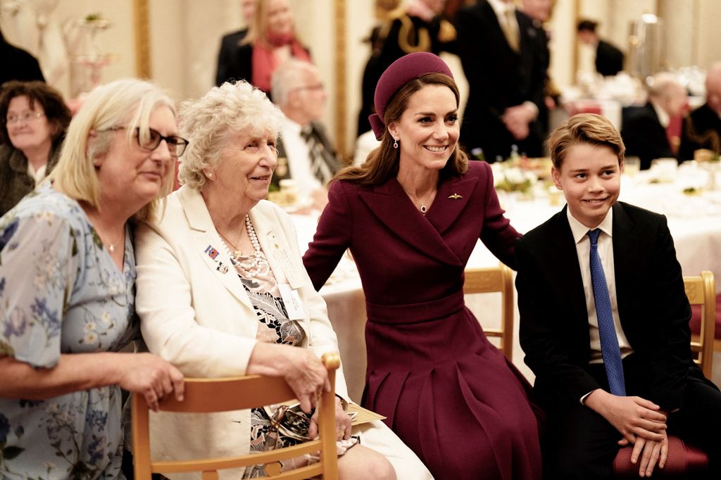 Kate and George smiling with veterans