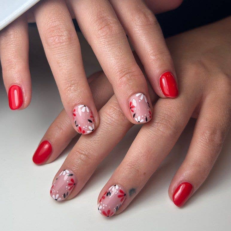 Large nail beds framed with red and white botanical illustrations