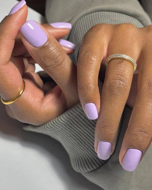 Soft pastel lavender manicure on short nails, a perfect floral-inspired nail colour for the spring season.