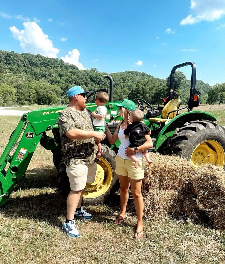 luke combs with wife and children near a tractor