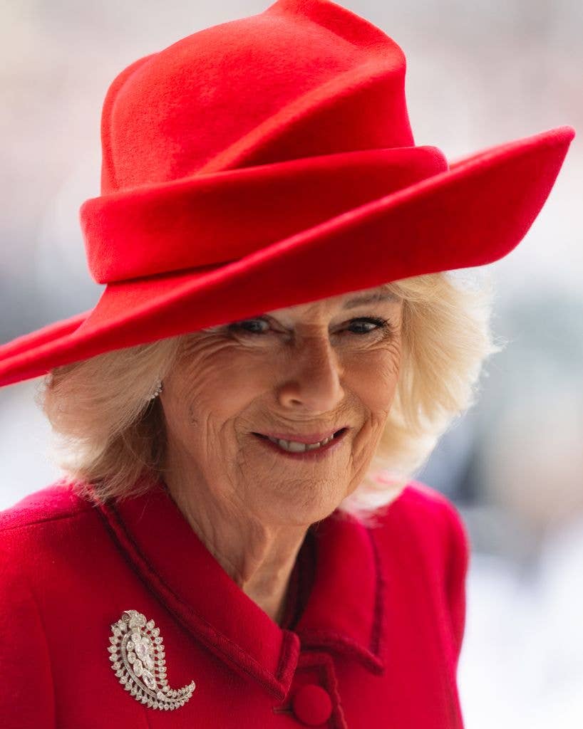 Queen Camilla up close in red coat dress and hat