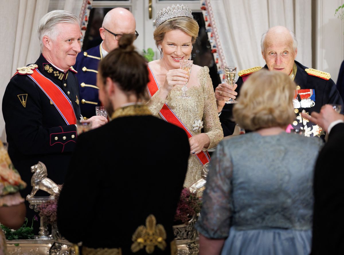 Queen Mathilde of Belgium paired elegance with historical resonance, wearing a champagne-gold gown by Armani Privé and the storied Nine Provinces Tiara