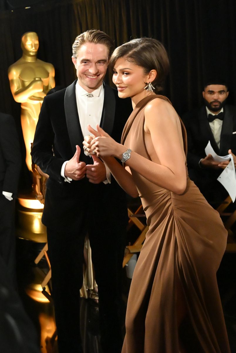 Robert Pattinson and Zendaya pose backstage during the 98th Oscars.