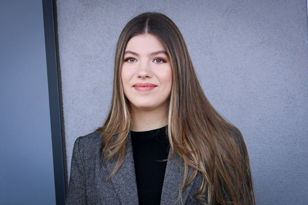 Infanta Sofia of Spain in a high neck black top and grey jacket.