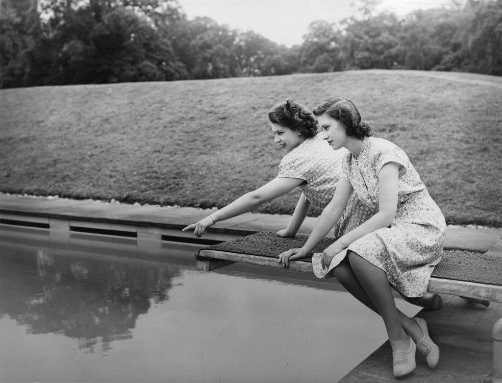 Princess Elizabeth and Princess Margaret (1930 - 2002) by the pool in the gardens at the Royal Lodge