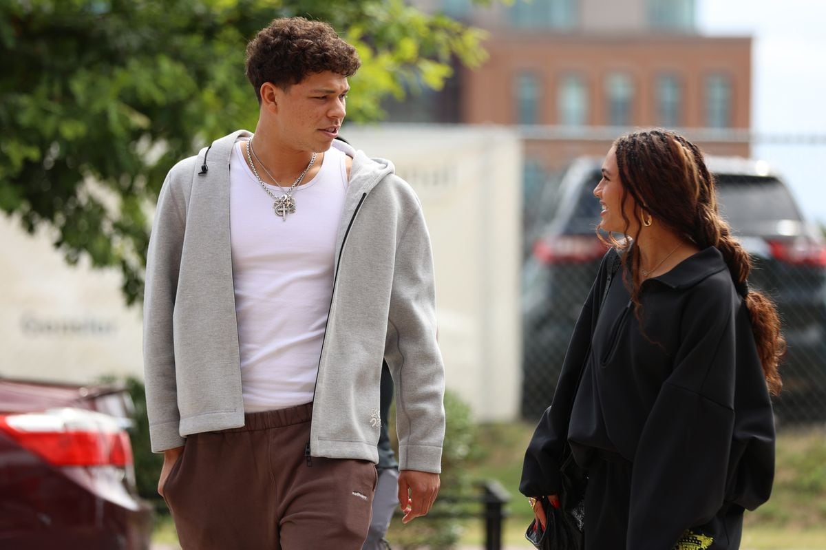 Trinity Rodman and Ben Shelton share a sweet kiss at a friend's wedding