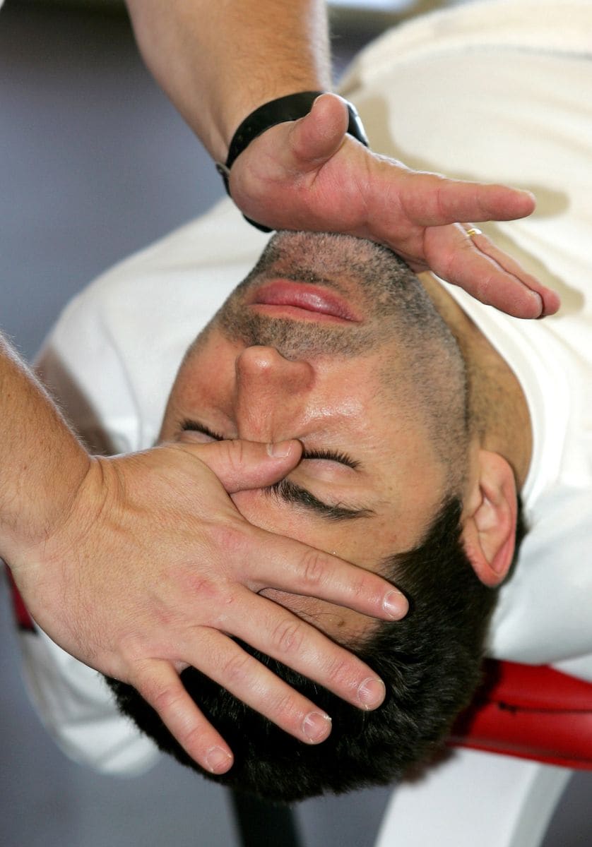 Arizona Cardinals new quarterback Kurt Warner stretches his neck on the first day of optional workouts at the Cardinals Tempe training facility.