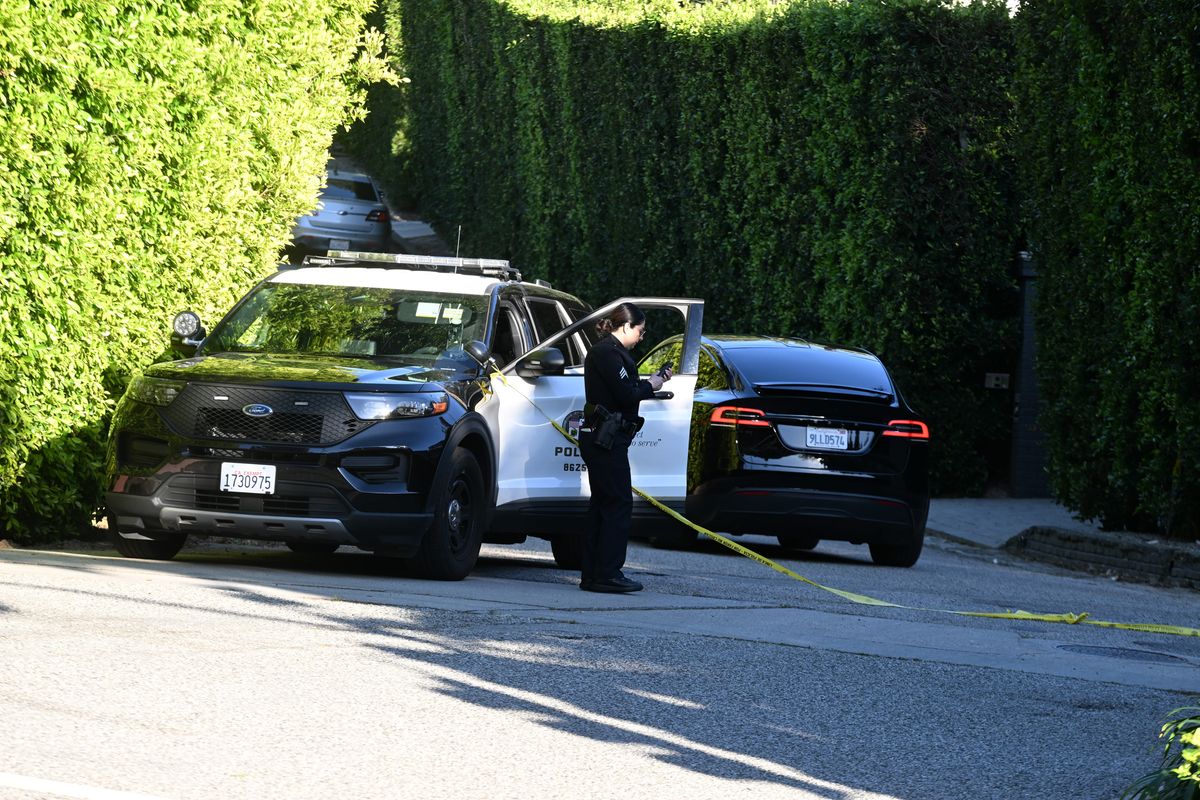 A police officer is seen outside of Rihanna's Beverly Hills home after a report of gunshots fired on March 08