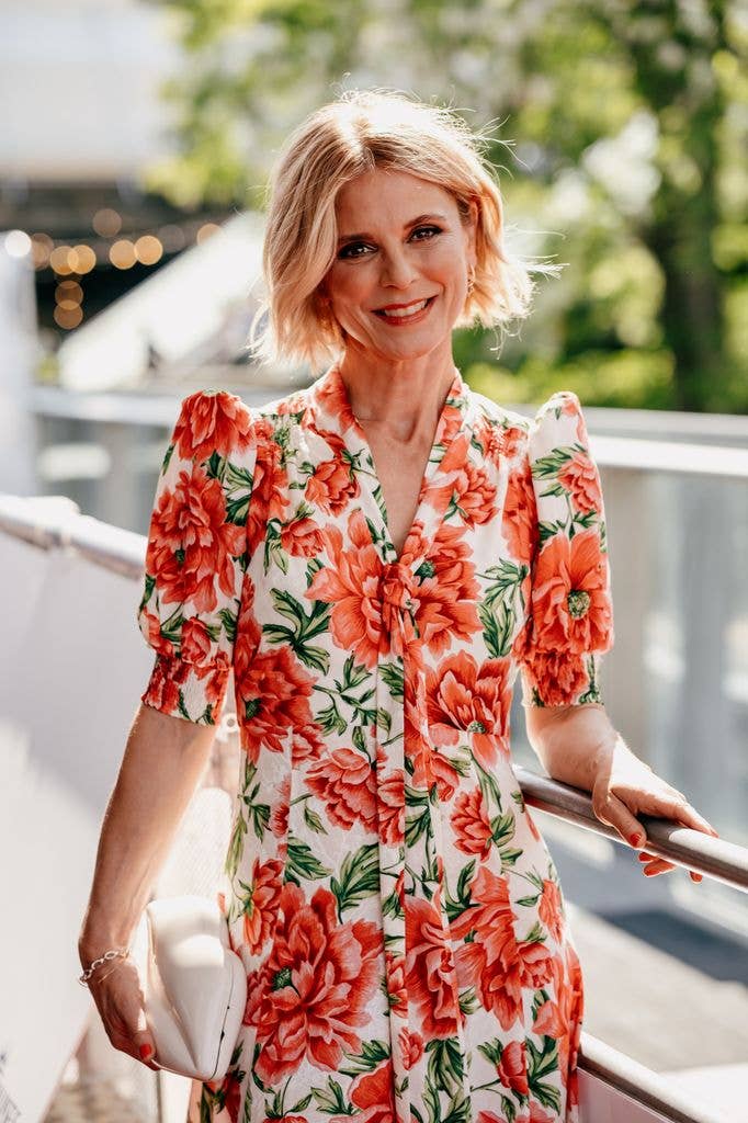 Emilia Fox smiles in peachy floral dress