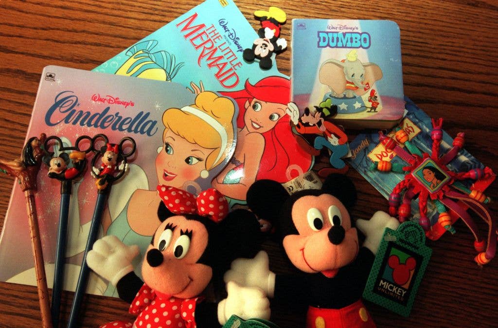 A collection of Disney toysand books from the Nineties, including Micky Mouse and Minnie Mouse dolls, pencils and Pocahontas jewellery.