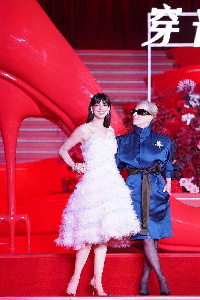 Anne Hathaway in ruffled dress and Meryl Streep  in blue dress