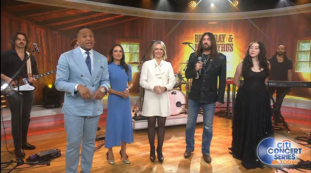 Dylan teamed her statement mini dress with a pair of sky high black heels 