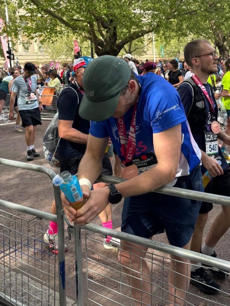 A photo of James Norton leaning over a silver gate
