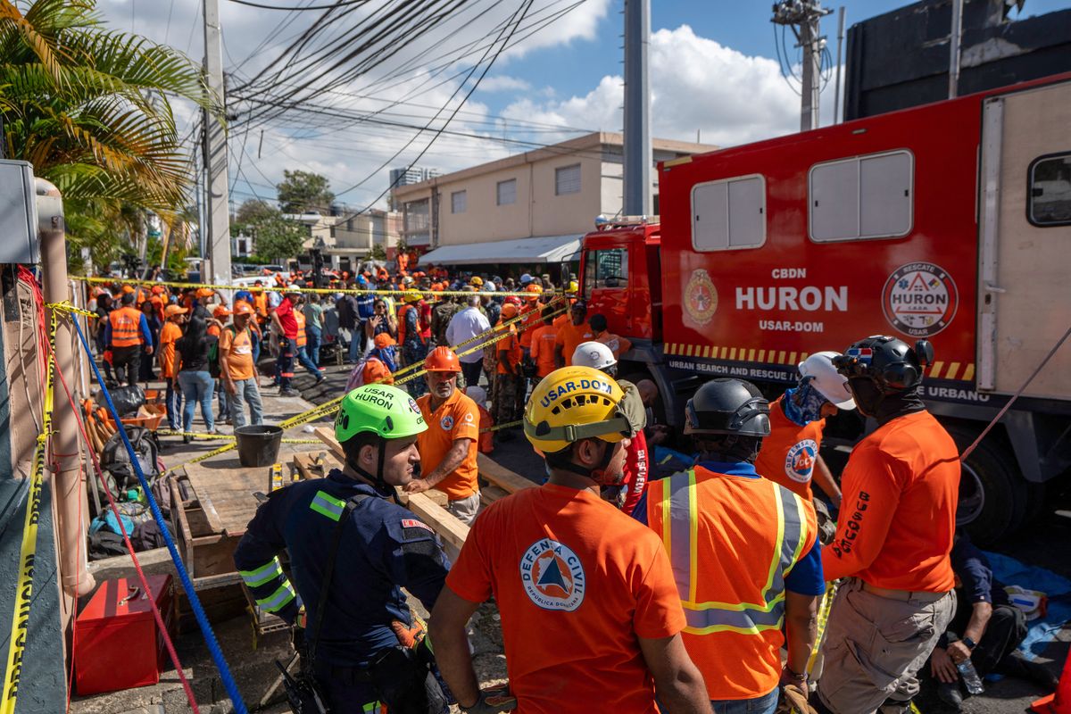 Personnel of Civil Defence and firefighters remove rubble from the Jet Set nightclub following the collapse of its roof, in Santo Domingo, on April 8, 2025.