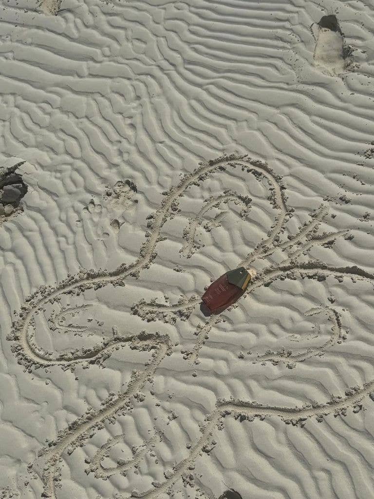 Ôrəbella's hair and body mist in the sand