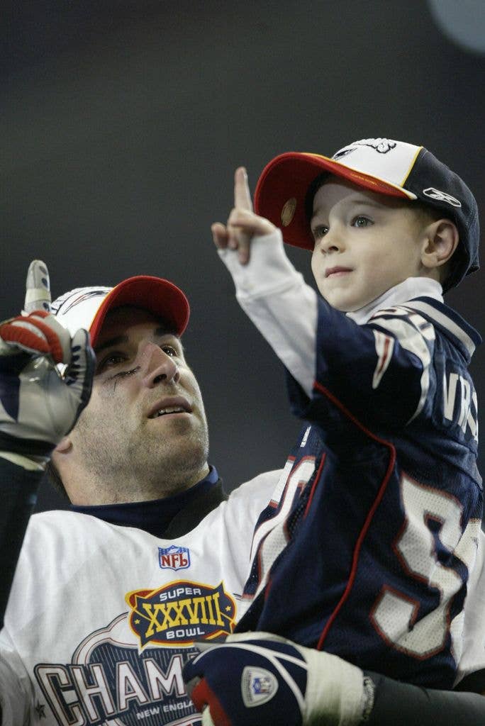 uper Bowl XXXVIII, Closeup of New England Patriots Mike Vrabel and son Tyler victorious after game vs Carolina Panthers, Houston, TX 2/1/2004