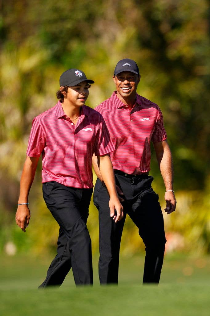 Tiger Woods of the United States and his son Charlie Woods walk on the fourth hole during the second round of the PNC Championship at Ritz-Carlton Golf Club on December 22, 2024 in Orlando, Florida.