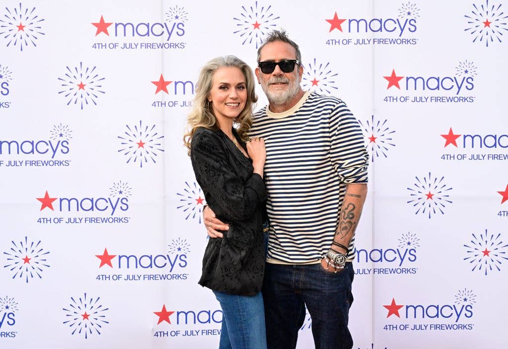 Hilarie Burton  and Jeffrey Dean Morgan attend Macy's 4th Of July Fireworks. Jeffrey wears a striped tshirt and dark jeans, holding an arm around wife Hilarie who wears a black velvet jacket and denim jeans.