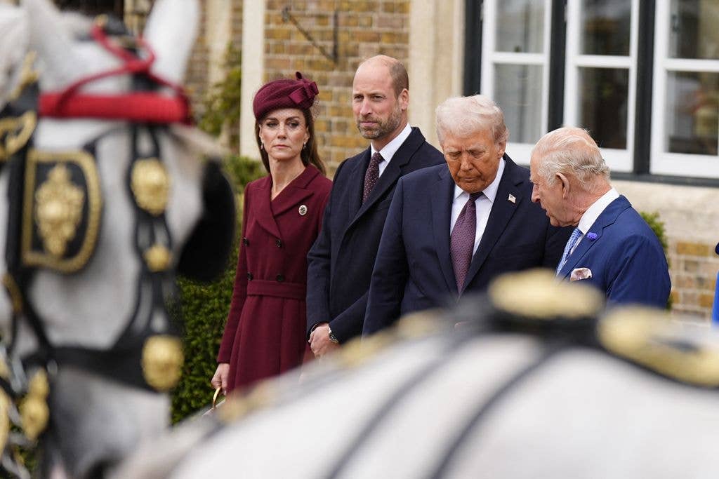 Britain's King Charles III talks with US President Donald Trump, accompanied by Britain's Prince William, Prince of Wales and Britain's Catherine, Princess of Wales, as they await for carriages, after their arrival in the grounds of Windsor Castle, in Windsor, on September 17, 2025