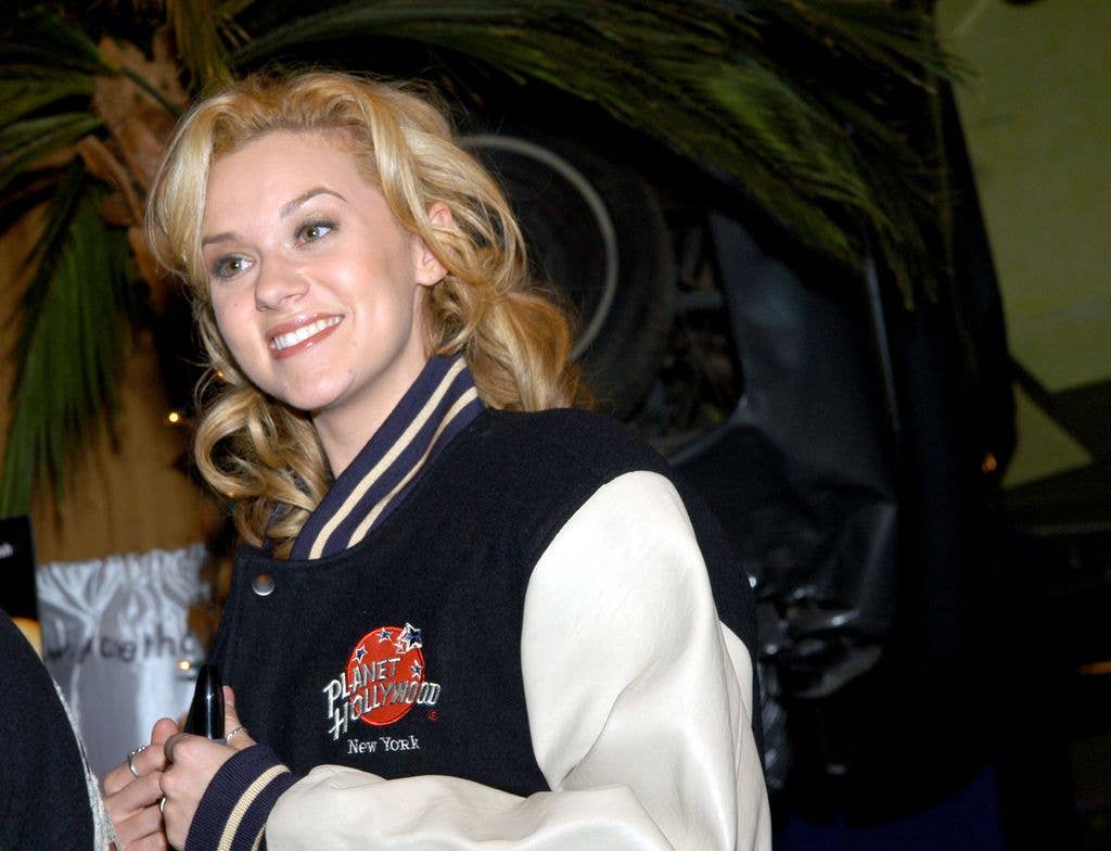 Hilarie Burton walking at a Planet Hollywood in a Planet Hollywood sport jacket.