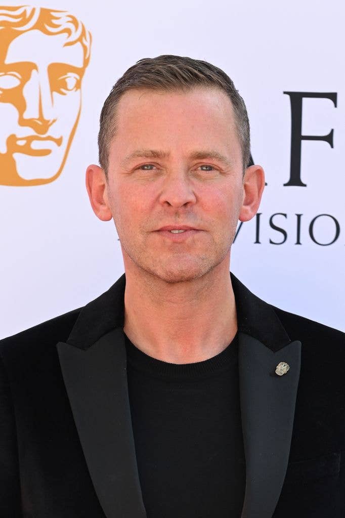 Scott Mills in a black suit