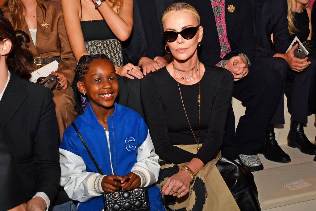 charlize theron sitting front row of fashion show with daughter