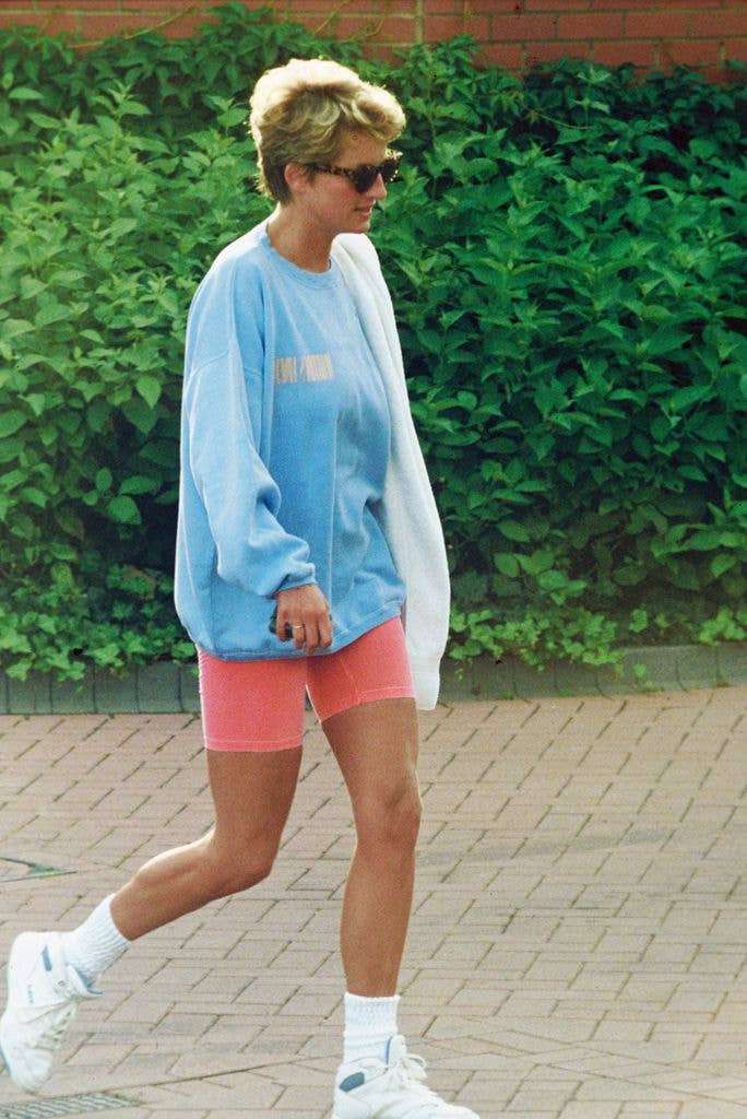 Diana, Princess of Wales, wearing a pale blue sweatshirt, pink cycling shorts and sunglasses, leaves Chelsea Harbour Club