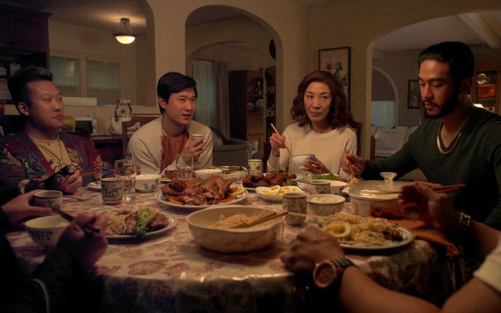 Joon Lee, Sam Song Li, Michelle Yeoh and Justin Chien sat around a dinner table in a still from The Brothers Sun