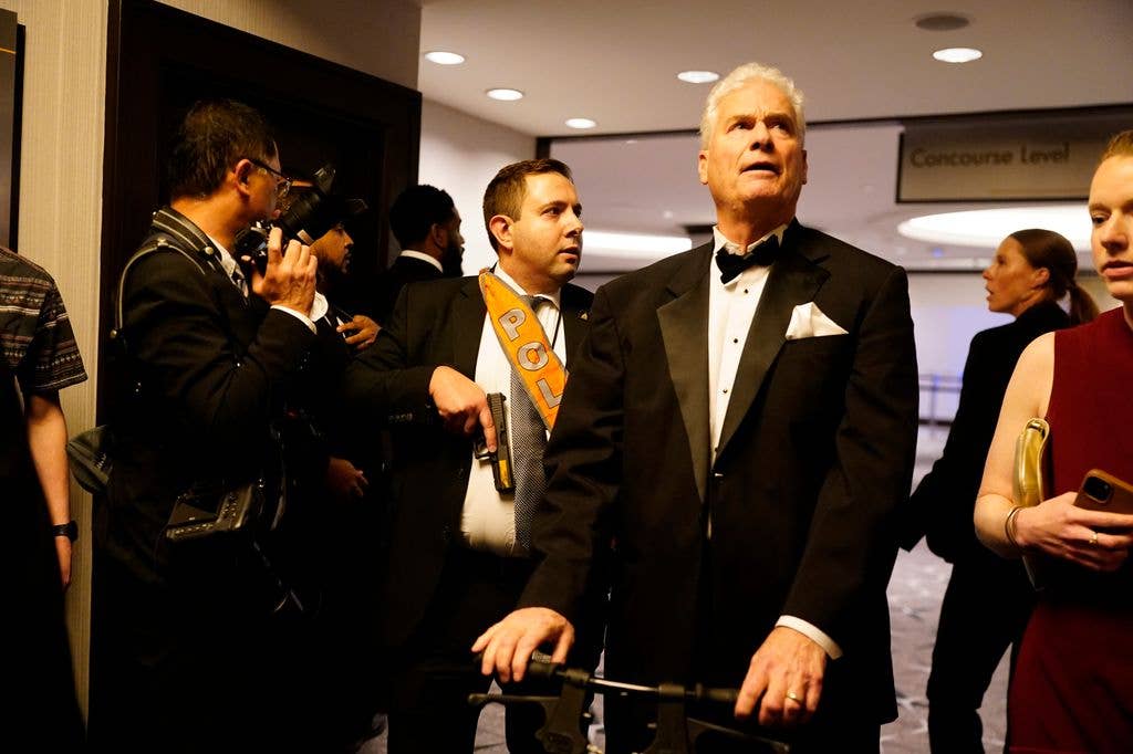 Agents escort people out of the Washington Hilton after an incident at the annual White House Correspondents Association Dinner