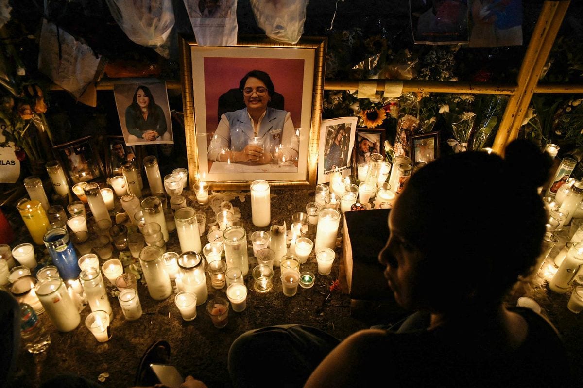 A portrait of one of the victims and candles are pictured while friends and relatives pay tribute to the victims in front of the Jet Set nightclub in Santo Domingo.
