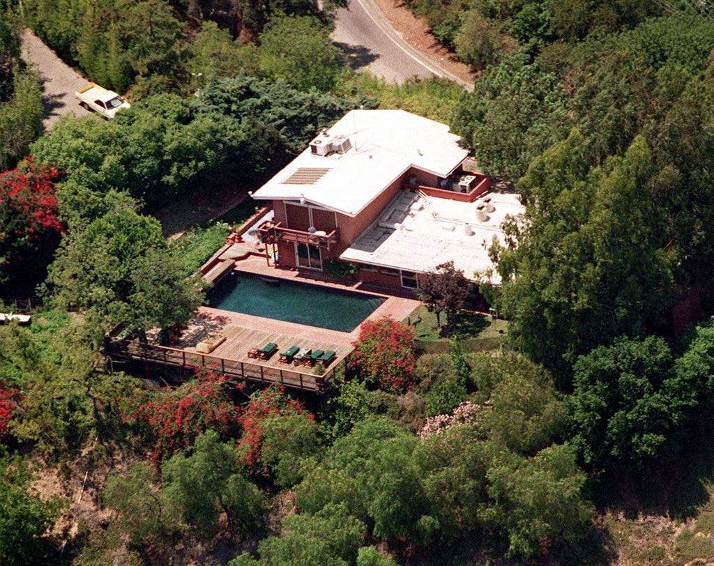 The beautiful house sits on acres of land and features a terrace overlooking the Franklin Canyon Reservoir