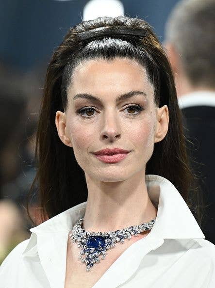 Anne Hathaway at The 2025 Met Gala with her hair scraped back with a hair clip made of hair
