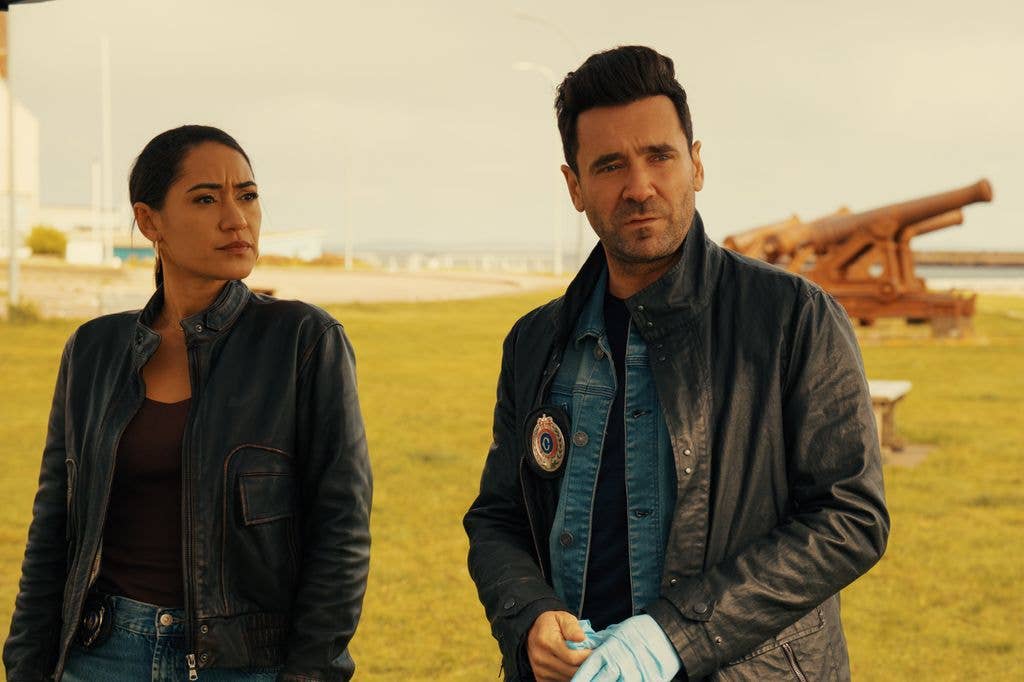 two police officers in leather jackets outdoors