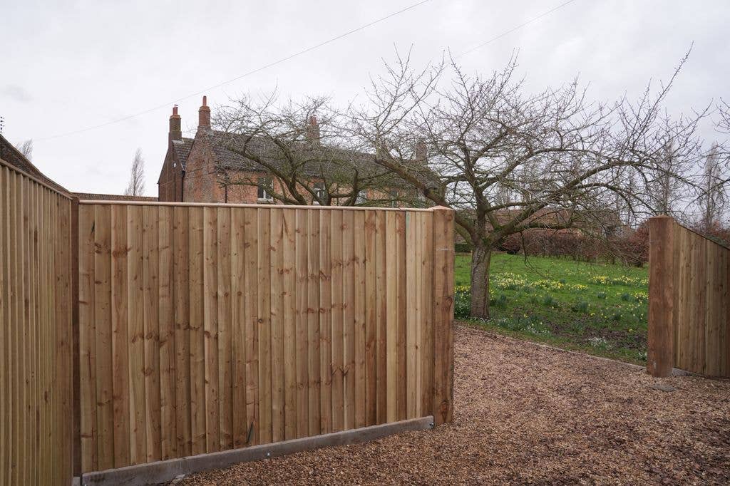 fence in front of farmhouse
