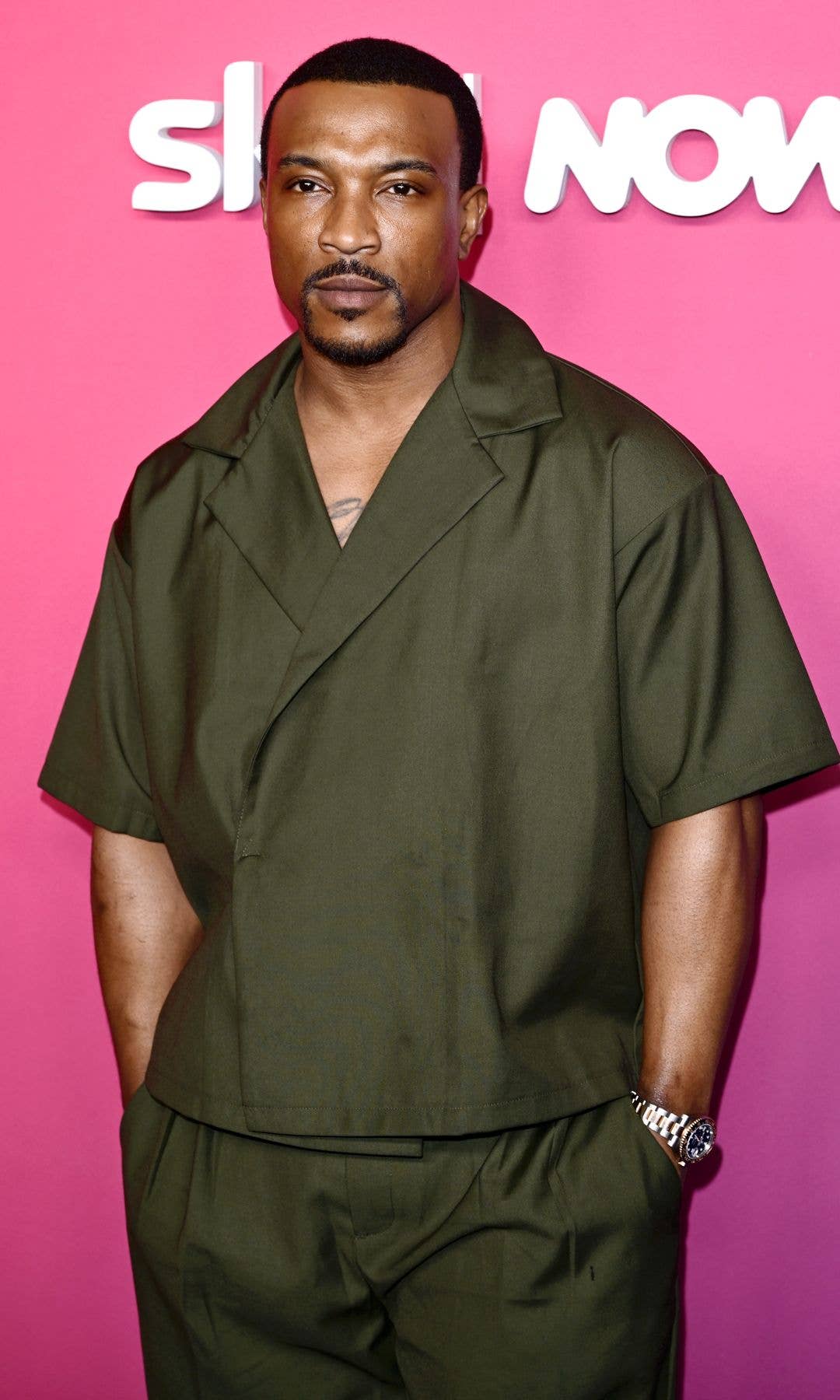 Ashley Walters wearing a forest outfit